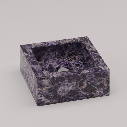 Square vanity sink in polished amethyst stone with rich purple veining and geometric form