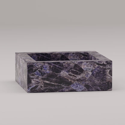 Square vanity sink in polished amethyst stone with rich purple veining and geometric form
